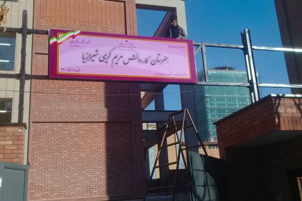 تابلوی فلکسی نصب شده روی سردر ورودی مدرسه و دبیرستان.